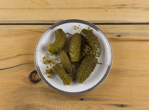Salted cucumbers on a wooden table