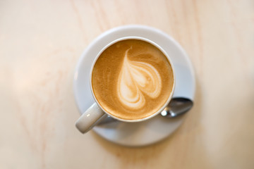Cappuccino cup on the brown wooden table