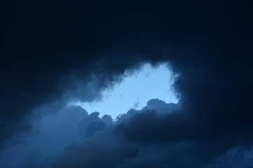 Fototapeta na wymiar Stormy clouds and window with serene blue sky