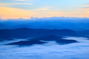 Layer of mountains in the mist at sunrise time