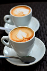 Delicious foamy cappuccino on the black background