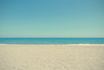 Pebbly white beach on a sunny day, against clear blue sky; can be used as summer background. Filtered image in faded, washed-out, retro style, with dark vignette; summer vintage concept. - 86157359