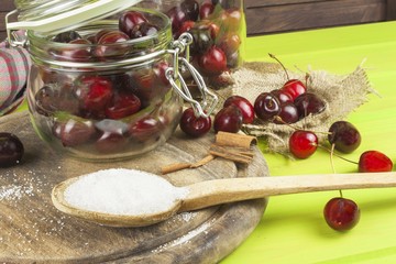 Domestic production of cherry jam. Freshly picked cherries ready for canning. The supply of fruits for the winter and a rainy day. The preparation of sweets for the family.
