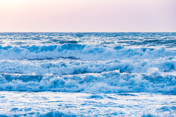 Naklejka na ściany i meble Sunset sunrise on the sea with beautiful waves