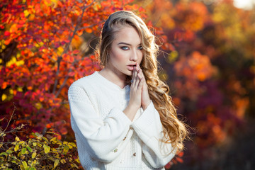 beautiful young woman with curly hair against a background of