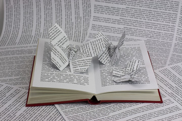 Origami butterflies coming out of a book