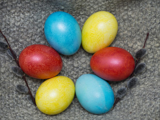 Easter eggs with willow branches on a wooden background