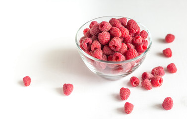 Fresh raspberries in the glass bowl