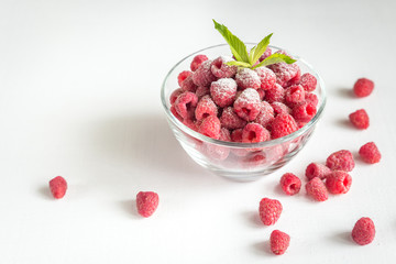 Fresh raspberries in the glass bowl