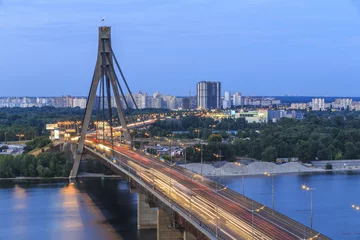 Deurstickers Bridge over Dnipro River in Kyiv city at sunset © elena_suvorova