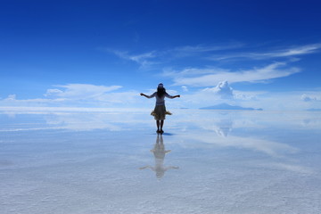 Reflection of a girl in Salar de Uyuni(Uyuni Salt Flat), Bolivia