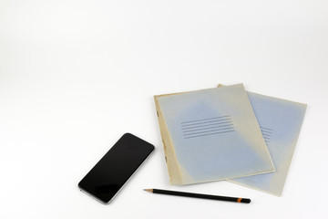 Smartphone, a notebook with black pencil - free space for text.
