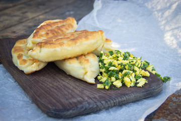Fried pies on a wooden chopping board