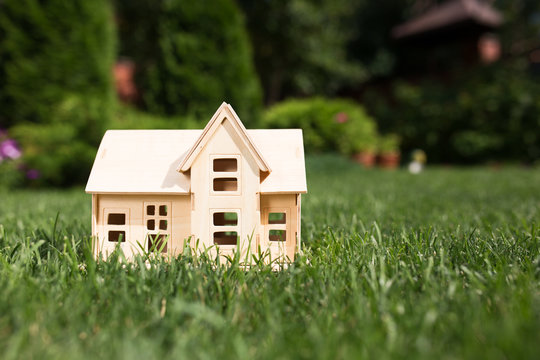 Wooden Model Of House On Grass,  Summer Outdoor, New Home Concep