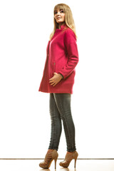 Full length fashion woman in red coat.