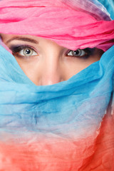 Fototapeta premium woman makeup on eyes hiden her face with shawl