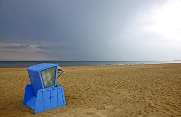 Fototapeta na wymiar Hooded beach chair at the Baltic sea in Swinoujscie, Poland