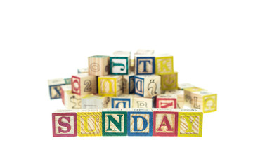 Sunday written in letter colorful alphabet blocks isolated on wh