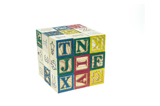 Stack of colorful alphabet blocks isolated on white