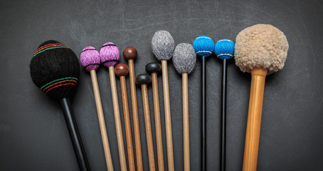 amazing detailed closeup view of drum and percussion orchestra natural hickory wood sticks on dark...