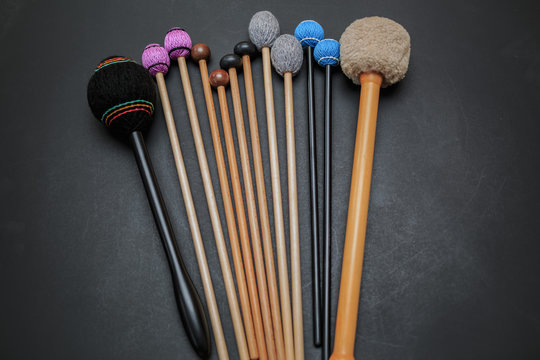 nice amazing closeup view of drum and percussion orchestra natural hickory wood sticks on dark grey background