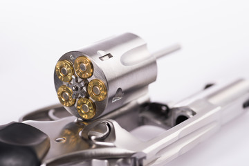 Macro shot of an open revolver loaded with bullets - obrazy, fototapety, plakaty
