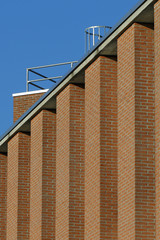 Red brick wall pattern against blue skies