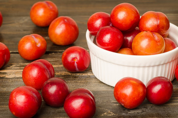 Fresh plum (Julee) on wooden background