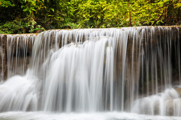 Water flowing over rocks in waterfall cascade in a forest