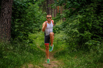 Obraz na płótnie Canvas Running man on nature path.