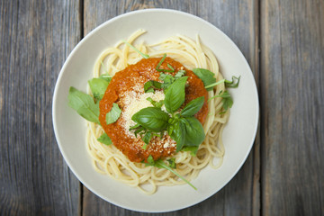 Homemade spaghetti with fresh basil, rucola and Parmesan