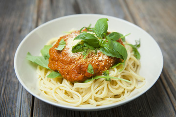 Homemade spaghetti with fresh basil, rucola and Parmesan