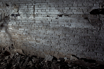 Image of grey aged ruined dark wall with concrete pieces