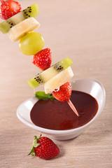 fruits on sticks and chocolate sauce