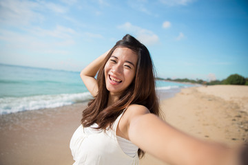 Happy young Asian woman take photos, smile to camera