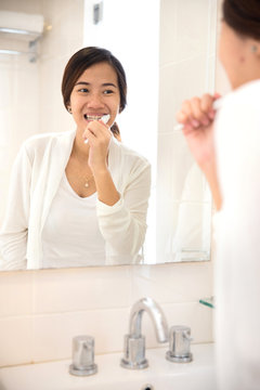 Asian young woman tooth brushing her teeth happily