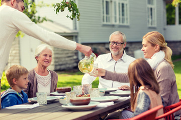 happy family having holiday dinner outdoors