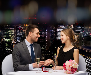 man proposing to his girlfriend at restaurant
