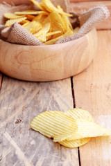 Potato chip on wood background