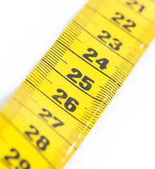 Yellow measuring tape isolated - selective focus