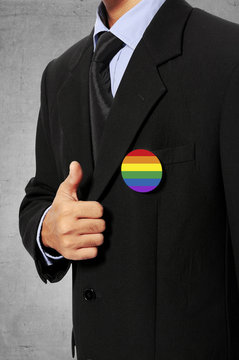 Business Man Show His Gay Flag Pin