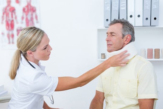 Doctor talking to patient wearing neck brace