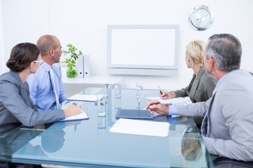 Business team looking at time clock 