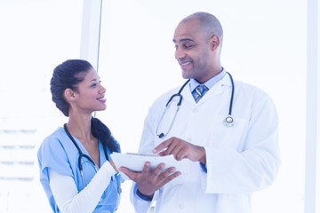 Fototapeta premium Smiling doctors reading files 