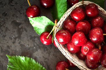Sweet Cherry with Water droplets on black plate