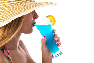 Young woman in bikini drinking a cocktail