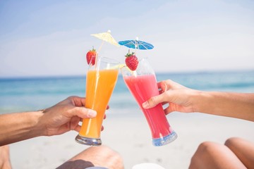 Couple toasting together at the beach