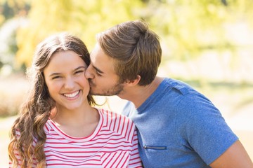 Obraz premium Cute couple kissing in the park