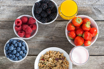 healthy breakfast with berries on wooden background, top view