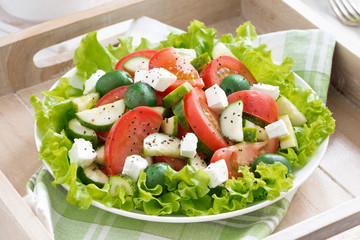 plate of green salad with vegetables, top view